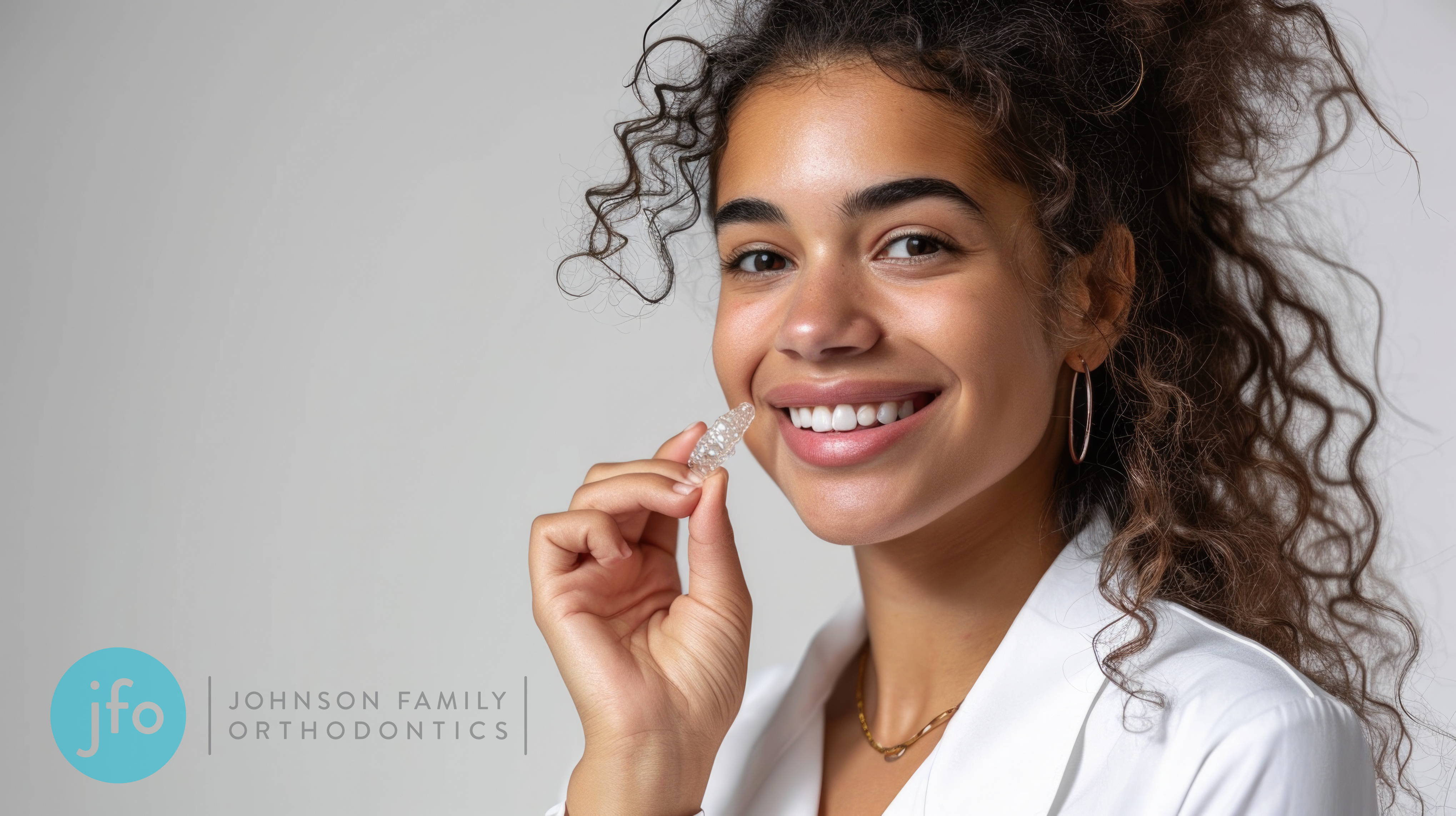 Girl with invisalign in hand